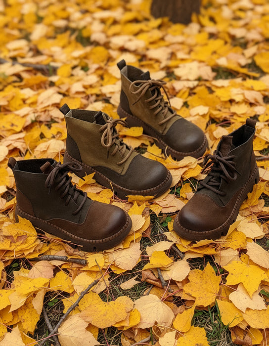 Set of brown leather boots on a textured gray background