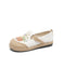 White espadrille shoe with floral embroidery on a white background