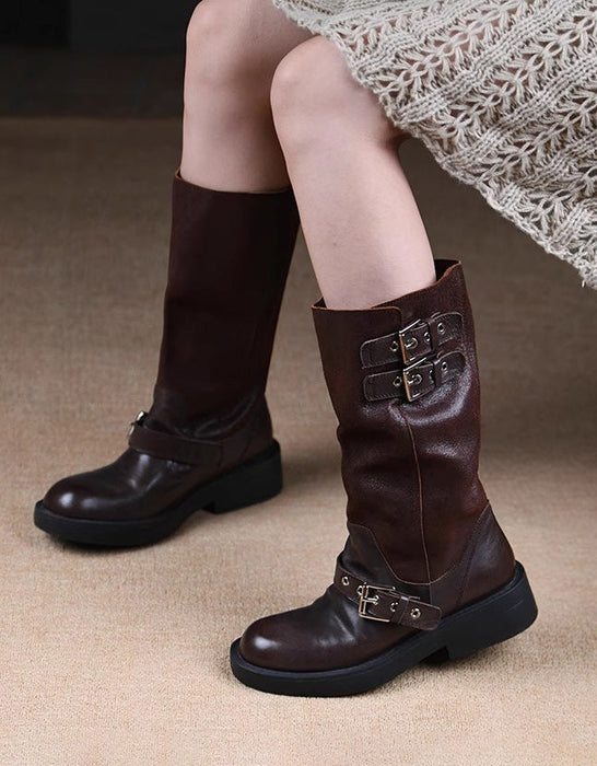Brown knee-high boots with buckles worn by a person on a beige carpet.