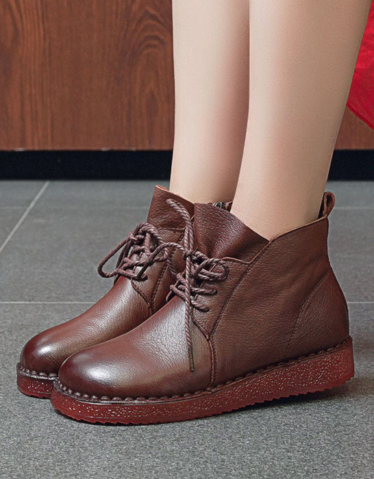 Brown leather boots worn by a person on a gray floor.