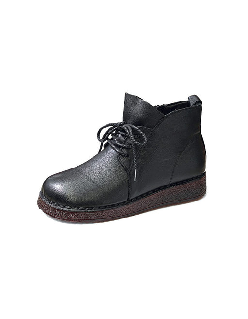 Black leather boot with a brown sole on a white background