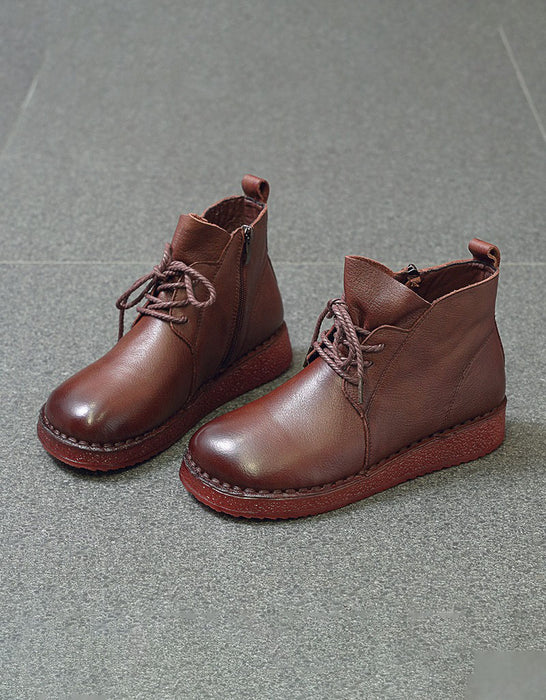 Pair of brown leather boots on a gray surface