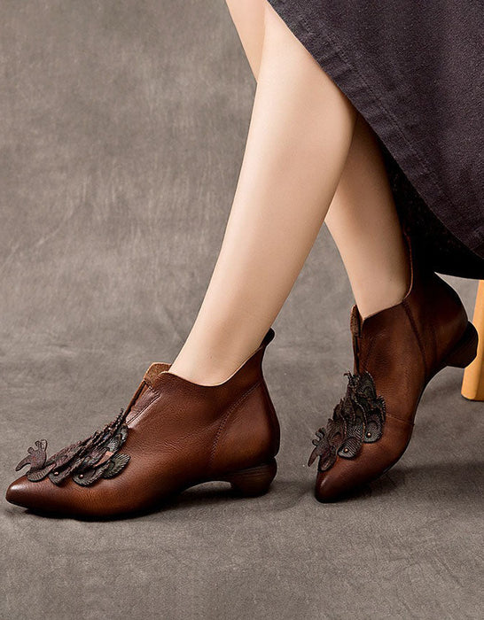 Brown leather shoes with decorative elements worn by a person on a gray background