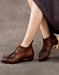 Brown leather shoes with decorative elements worn by a person on a gray background