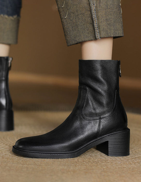 Black leather ankle boot on a blurred background
