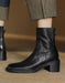 Black leather ankle boot on a blurred background