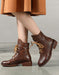 Brown leather boots worn with a matching skirt on a gray background